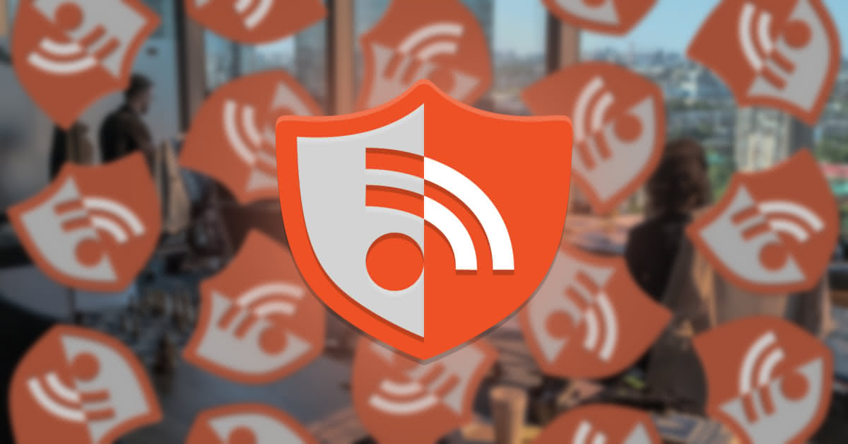 The application icon for RSS Guard, Papirus style, shown in front of a blurred office background